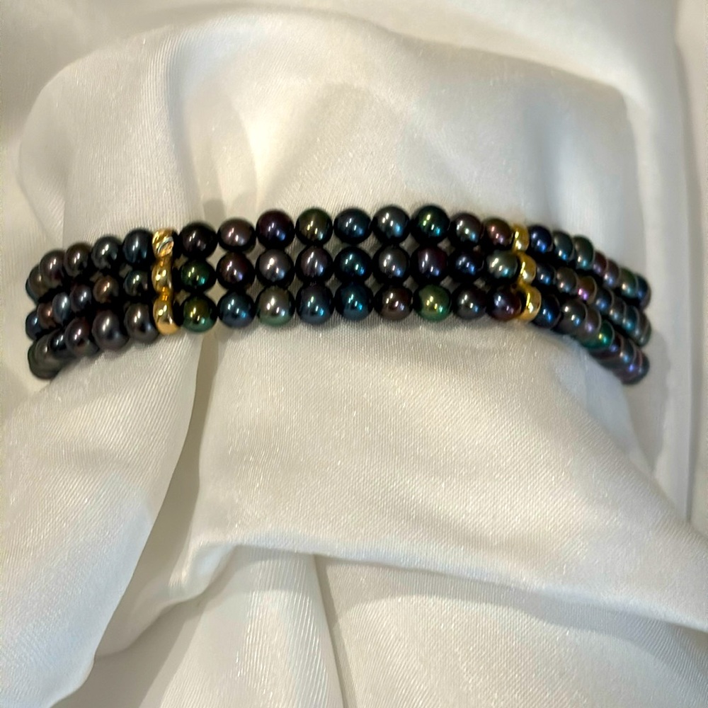 Tahitian black pearl bracelet with 14k gold filigree clasp.